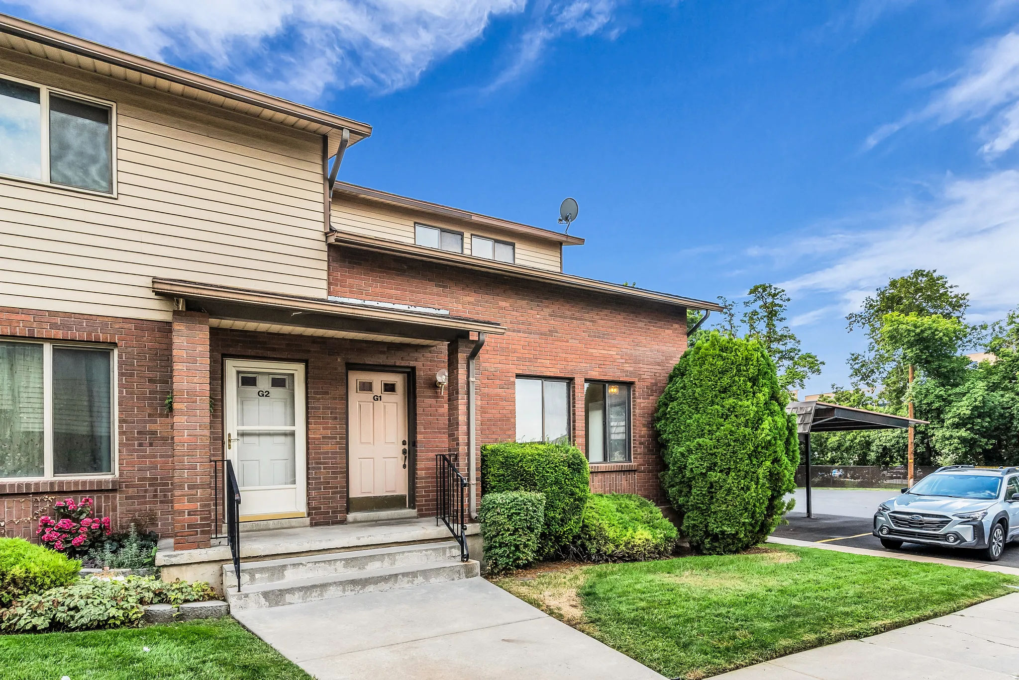 Brick and siding exterior with mature landscaping