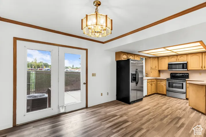 Wood-finish flooring throughout, with a classic chandelier and recessed ceiling lighting