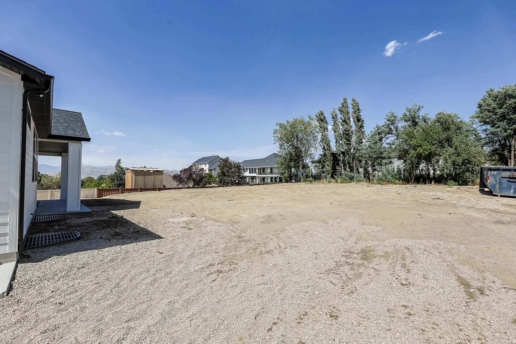 Expansive side yard with a gravel surface