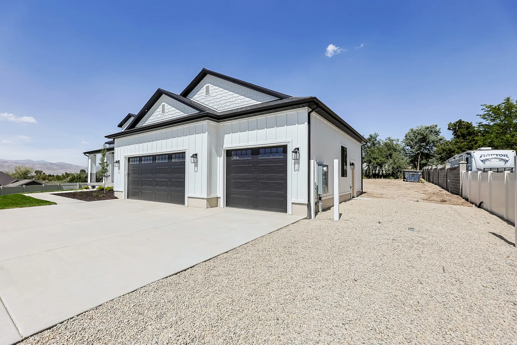 White board and batten siding with contrasting dark trim and shake accents
