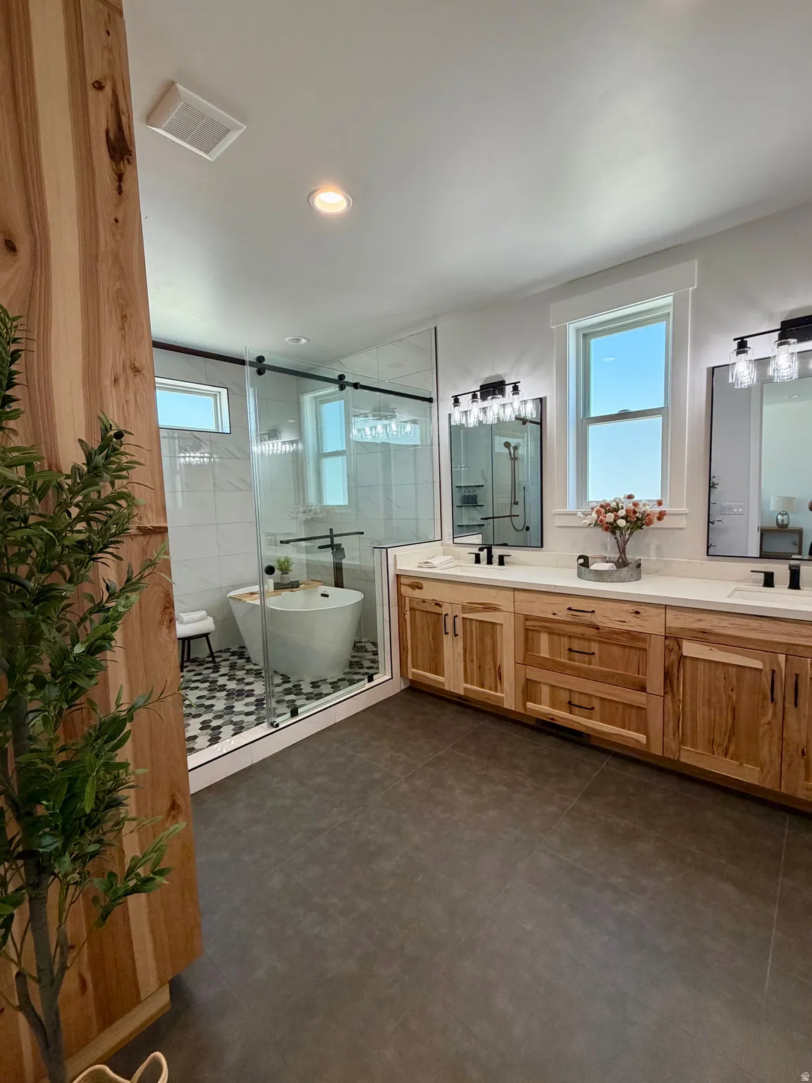 Dual sink vanity with wood-finish cabinetry and white countertops