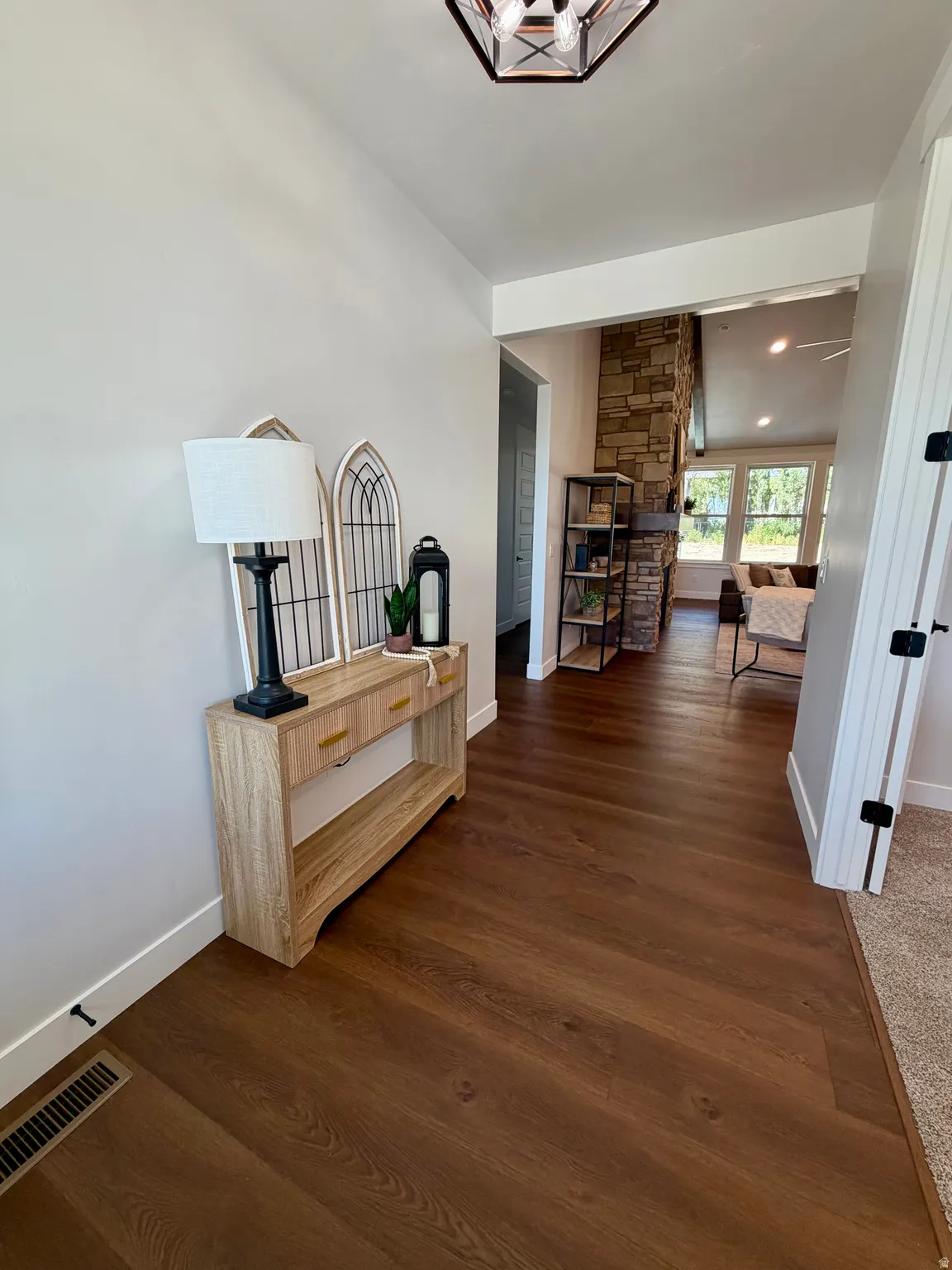 Warm wood-finish flooring extending into the main living area