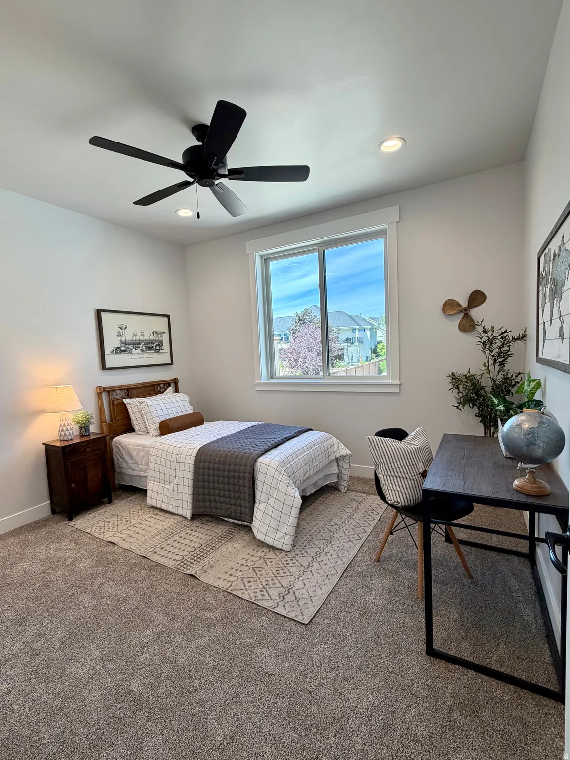 Carpeted room featuring a large window, recessed lighting, and a ceiling fan