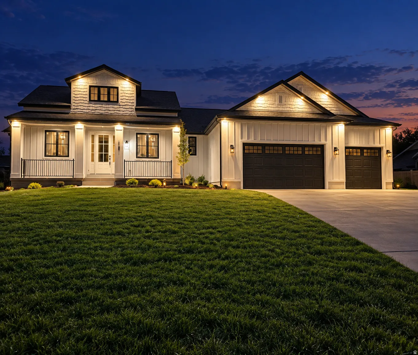 Modern farmhouse exterior with white vertical siding, black-framed windows, and a covered porch with black railings