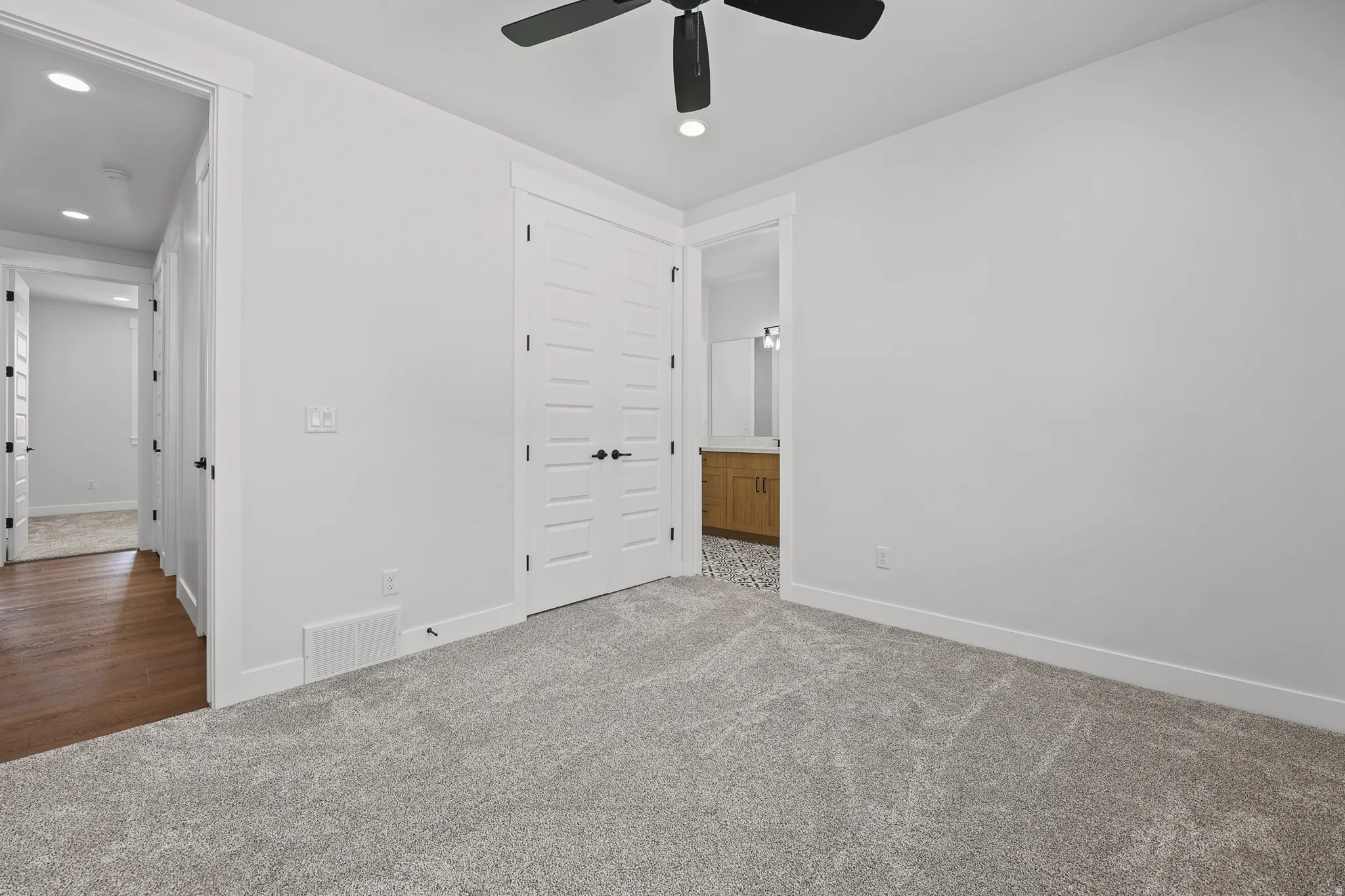 Plush carpet flooring, contemporary ceiling fan, recessed lighting, and white trim