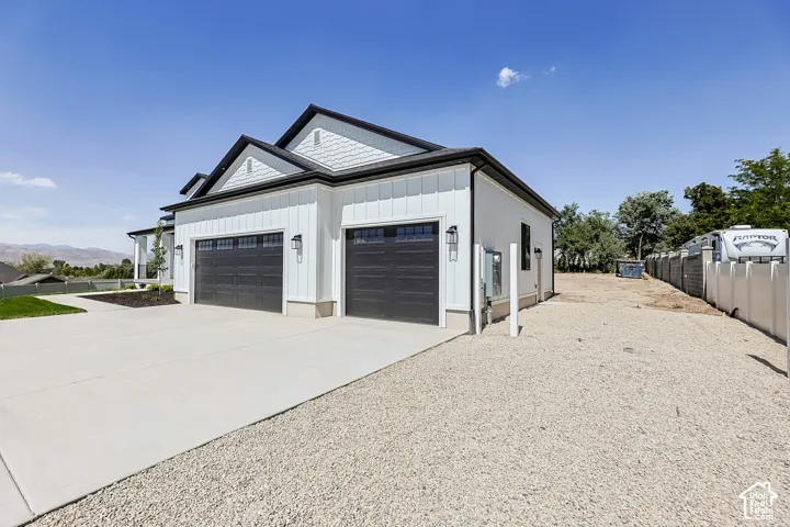 White board and batten siding with contrasting dark trim and shake accents