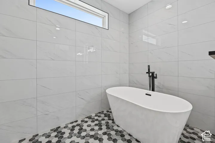 White freestanding soaking tub with matte black fixtures