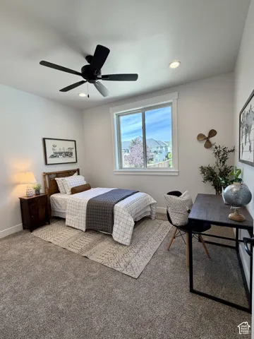 Carpeted room featuring a large window, recessed lighting, and a ceiling fan