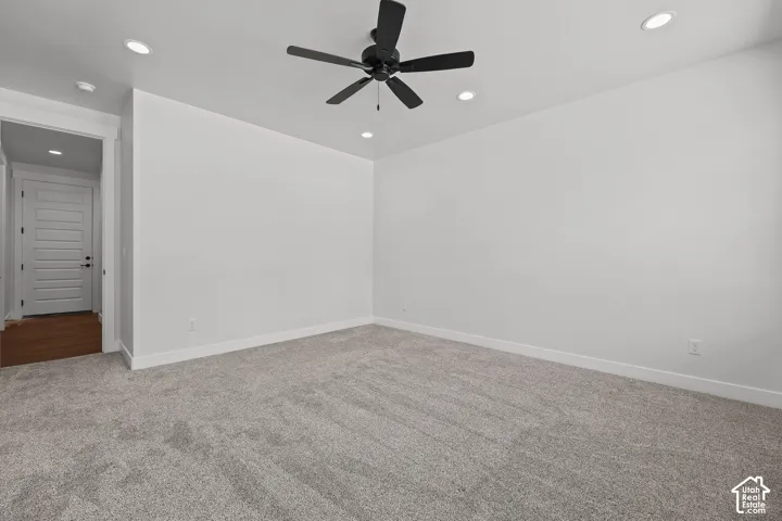 Recessed lighting, ceiling fan with matte black finish, light gray carpeting, white walls, and white trim