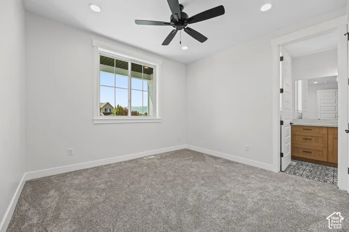 Carpeted room with recessed lighting and a ceiling fan