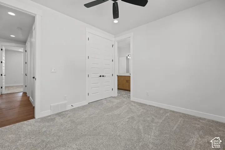Plush carpet flooring, contemporary ceiling fan, recessed lighting, and white trim