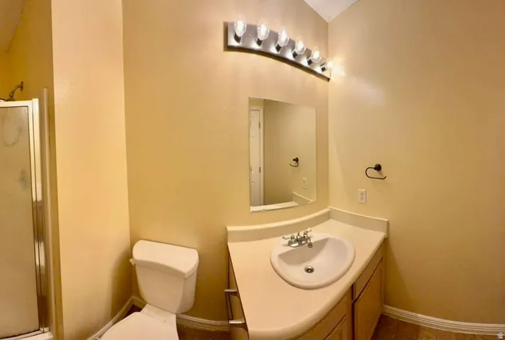 Vanity with integrated sink, chrome faucet, and under-counter cabinetry