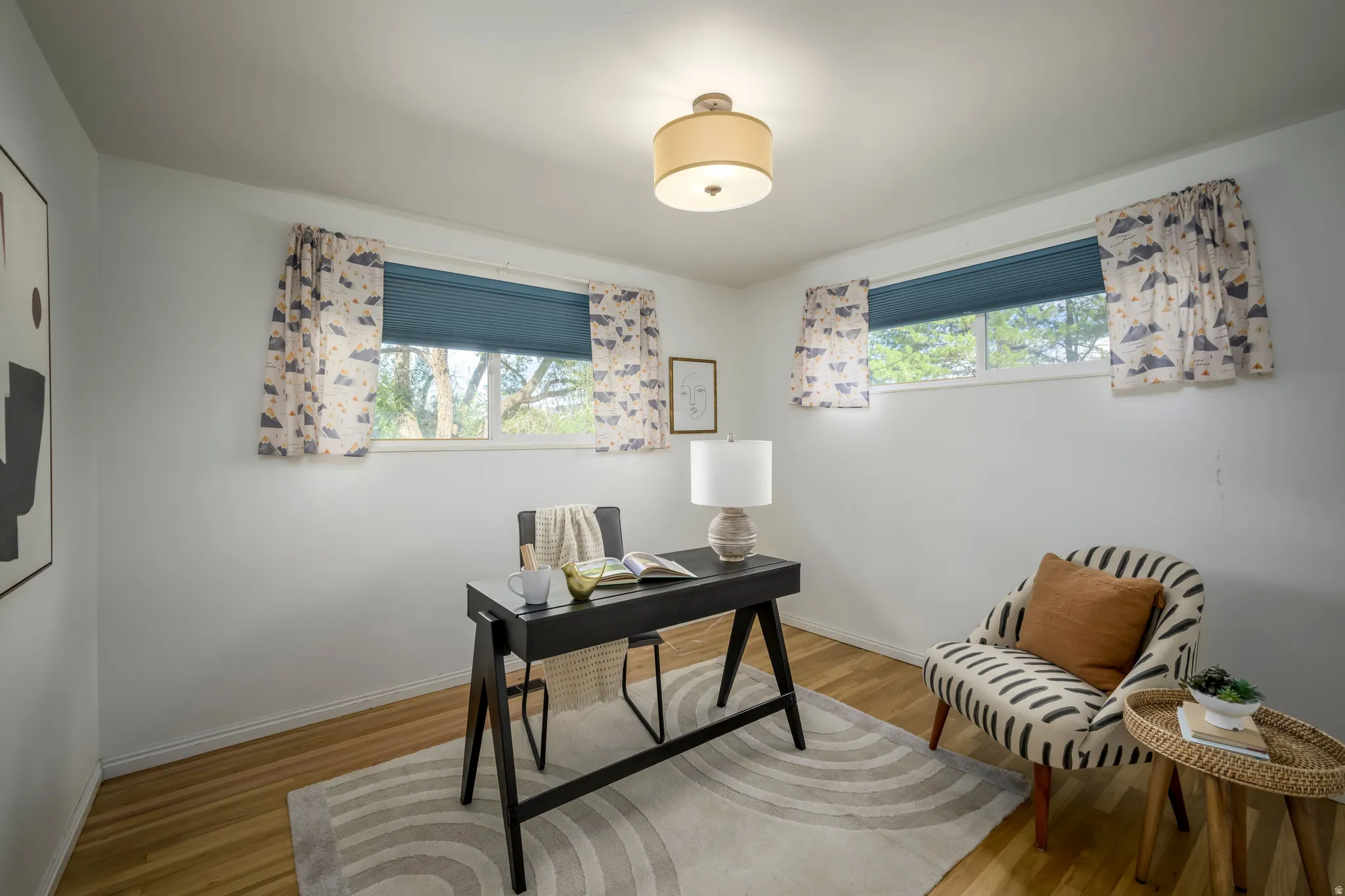 Wood-finish flooring with white walls and dual windows
