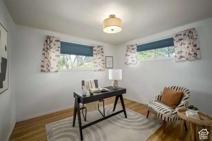 Wood-finish flooring with white walls and dual windows