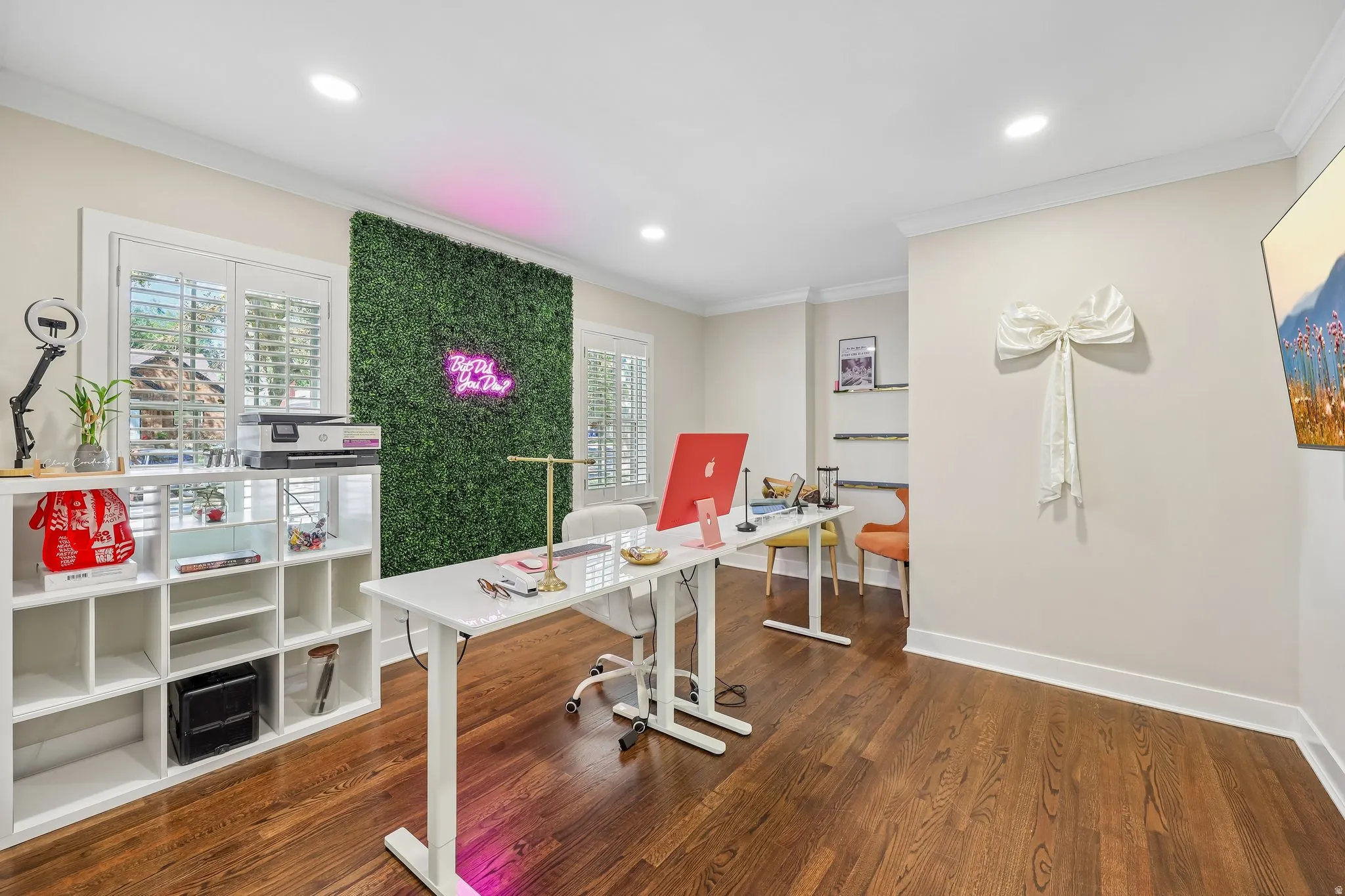 Rich wood-finish flooring, recessed lighting, and crown molding