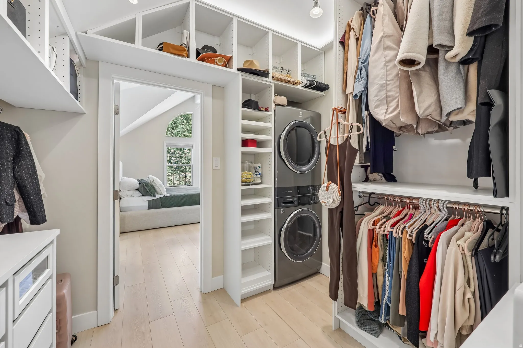 Custom closet system featuring built-in shelving, integrated drawers, and ample hanging space