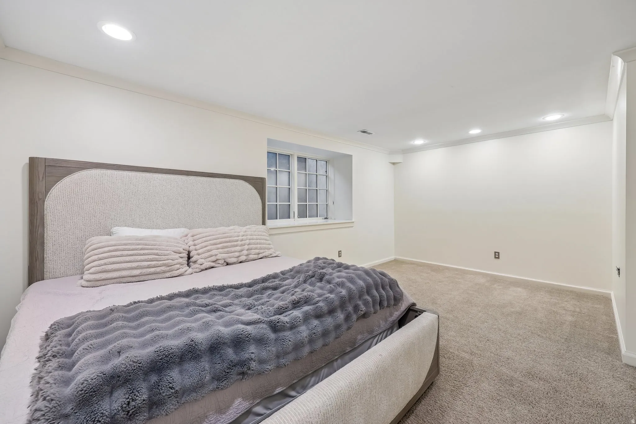 Recessed lighting, crown molding, white trim, and light-colored carpeting
