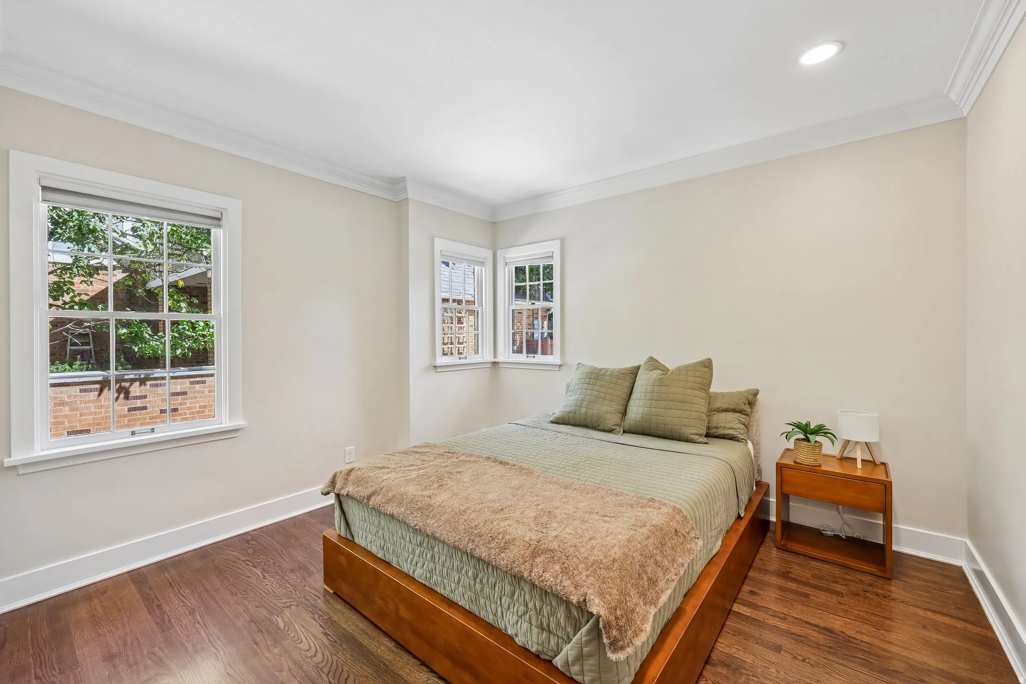 Hardwood flooring, crown molding, recessed lighting, double-hung windows, and bright wall finishes