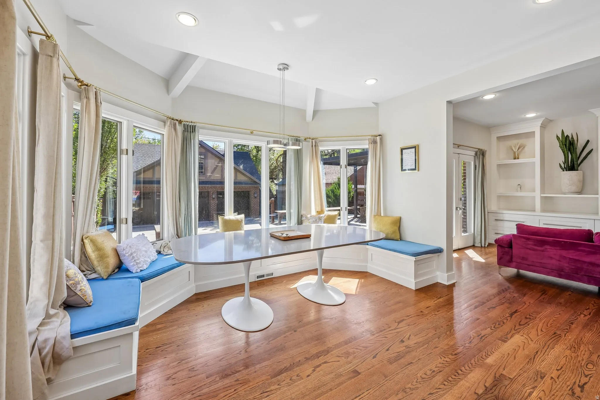 Hardwood flooring, recessed lighting, built-in window seating, multiple windows, and built-in shelving
