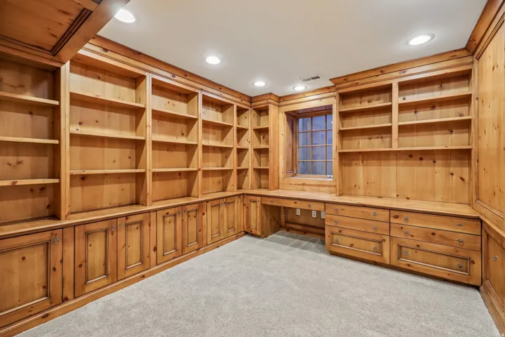 Built-in wood cabinetry with integrated shelving and desk space