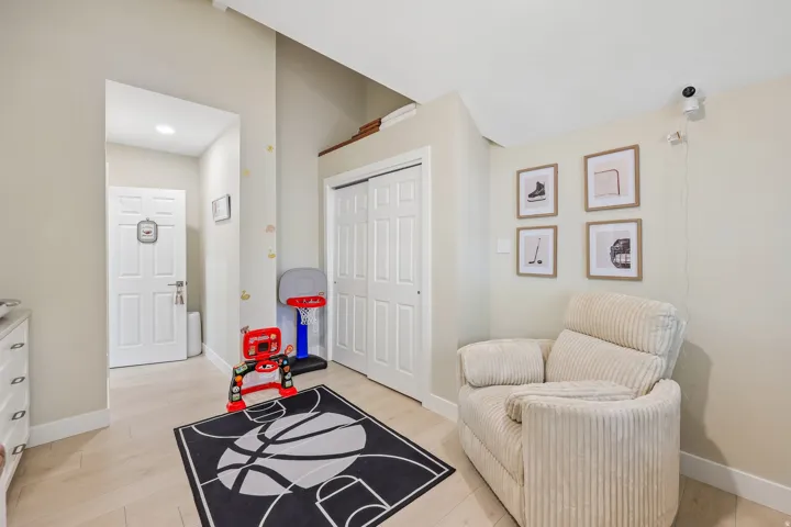Recessed lighting, wood-finish flooring, white paneled interior doors, and a double-door closet