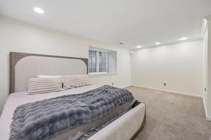 Recessed lighting, crown molding, white trim, and light-colored carpeting