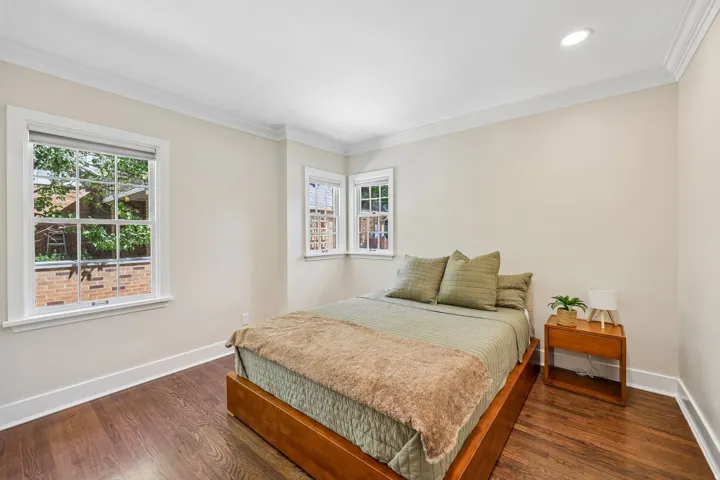 Hardwood flooring, crown molding, recessed lighting, double-hung windows, and bright wall finishes