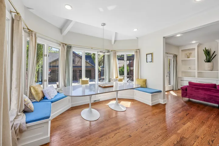 Hardwood flooring, recessed lighting, built-in window seating, multiple windows, and built-in shelving