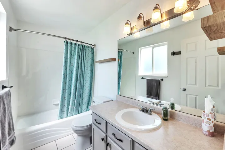 Integrated vanity with an oval basin, countertop, and mounted faucet