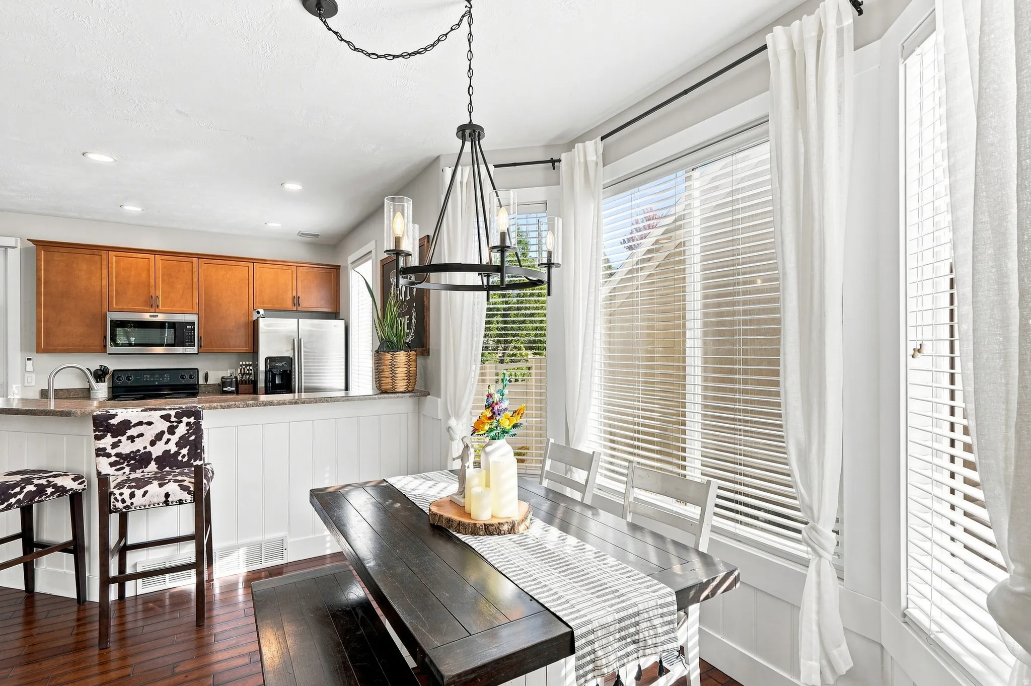 Kitchen with wood cabinetry, stainless steel appliances, and a breakfast bar