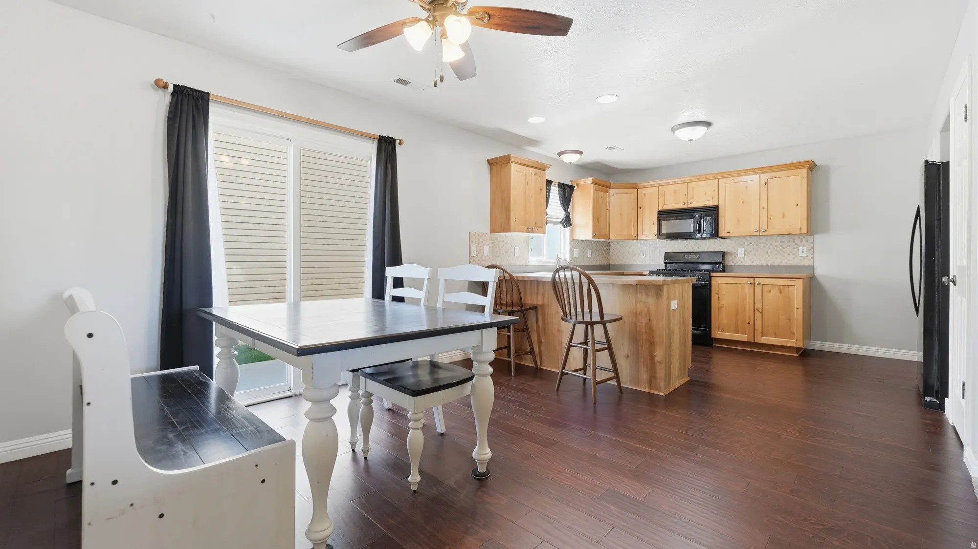 Spacious kitchen features abundant cabinet and counter space, breakfast bar seating, and an open layout perfect for everyday living and entertaining.