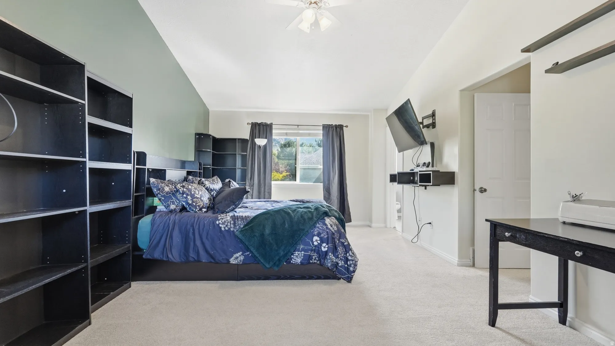 Large primary suite features vaulted ceilings, great natural light, and plenty of room to create a comfortable private retreat.