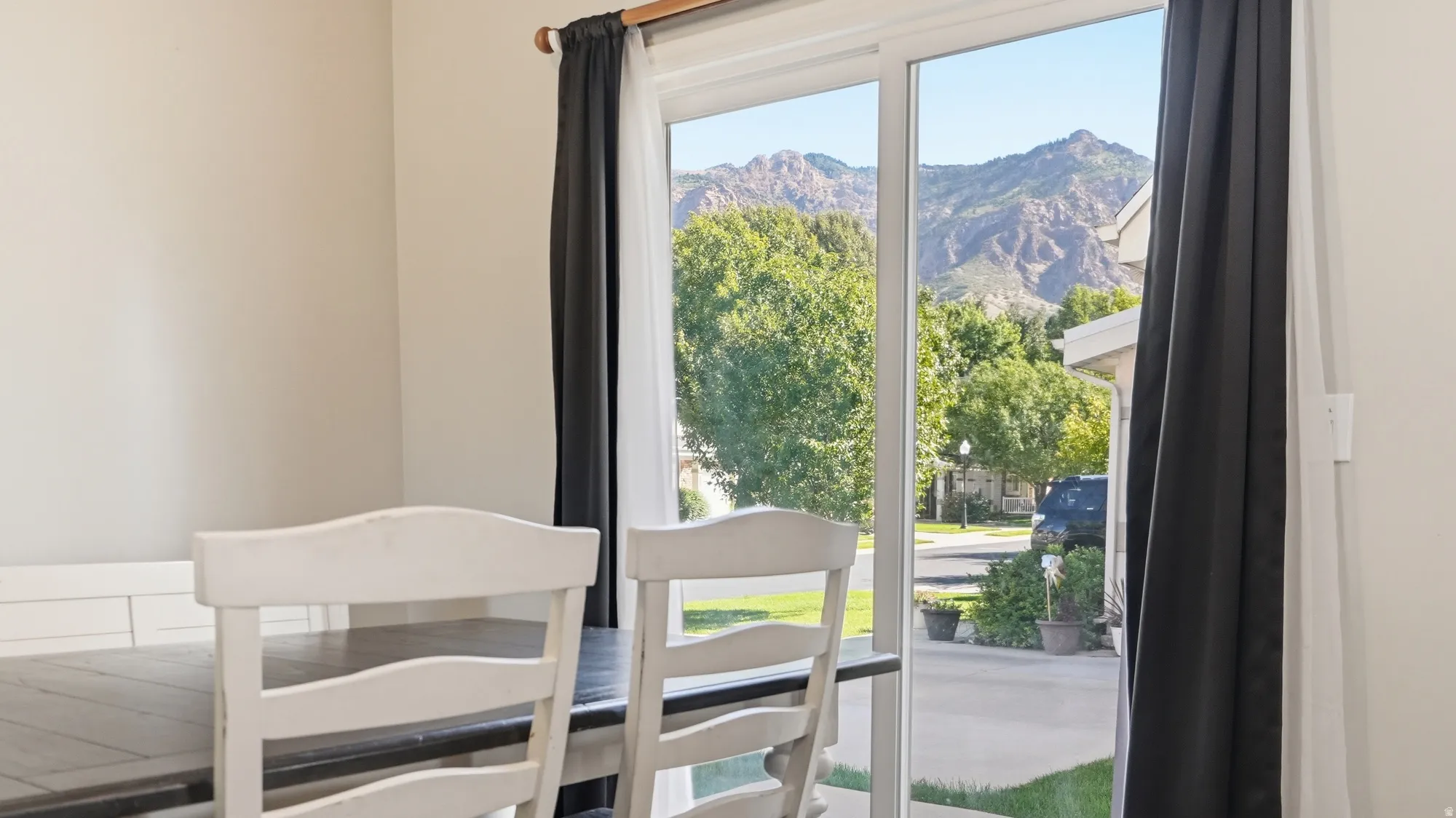 Dining area features a large sliding glass door showcasing beautiful mountain views and providing easy outdoor access.