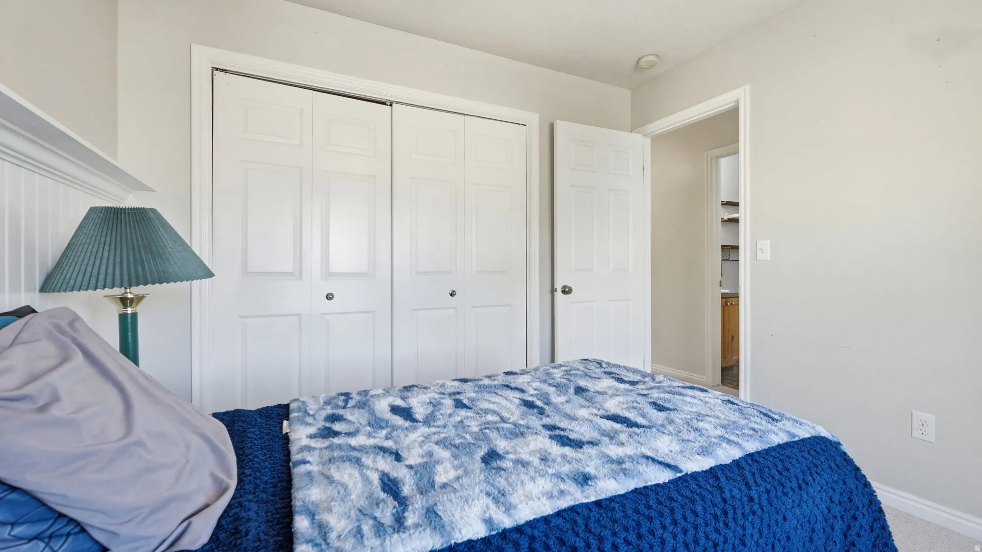 Additional view of the bedroom highlighting the spacious double-door closet and comfortable layout.