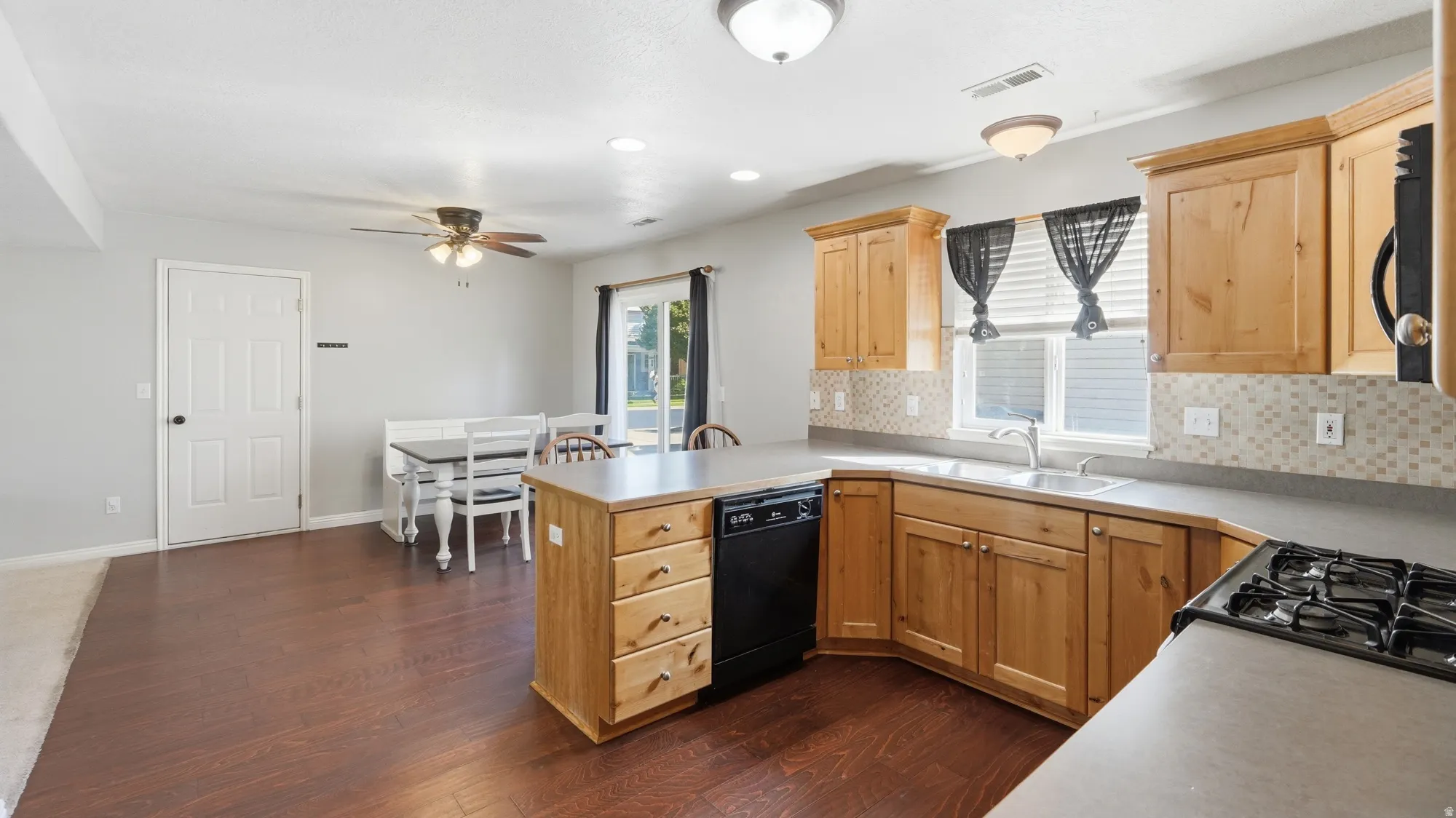 Open kitchen and dining layout with great natural light, ample cabinetry, dishwasher, and easy flow into the main living space.