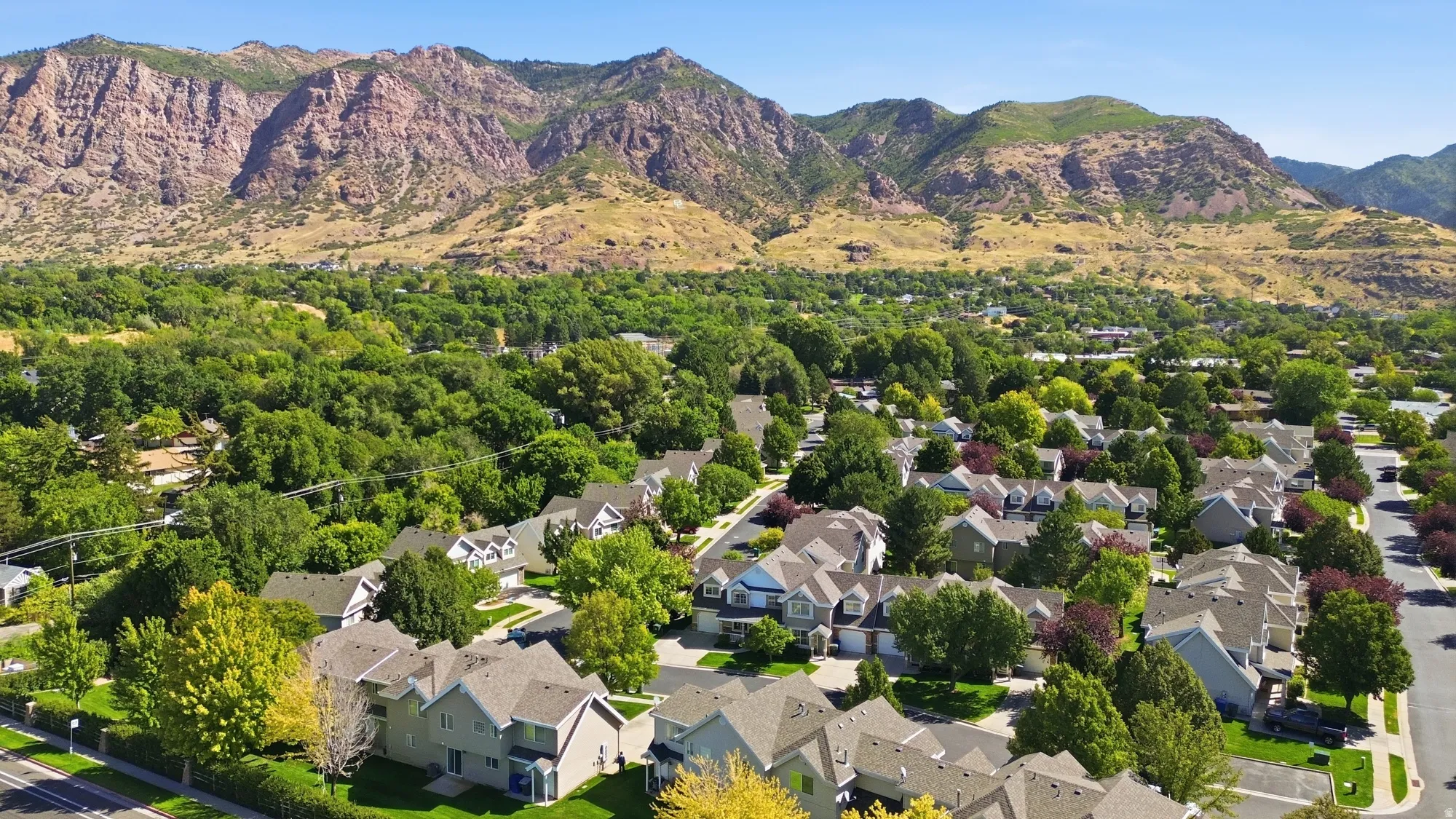 Aerial view showcasing the community setting with beautiful mountain scenery just beyond the neighborhood.