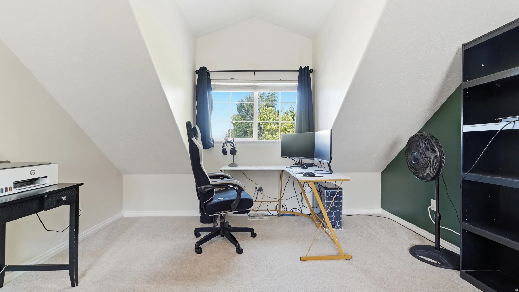 Bright built-in-feeling workspace area with a large window and plenty of natural light, tucked neatly into the spacious primary suite.