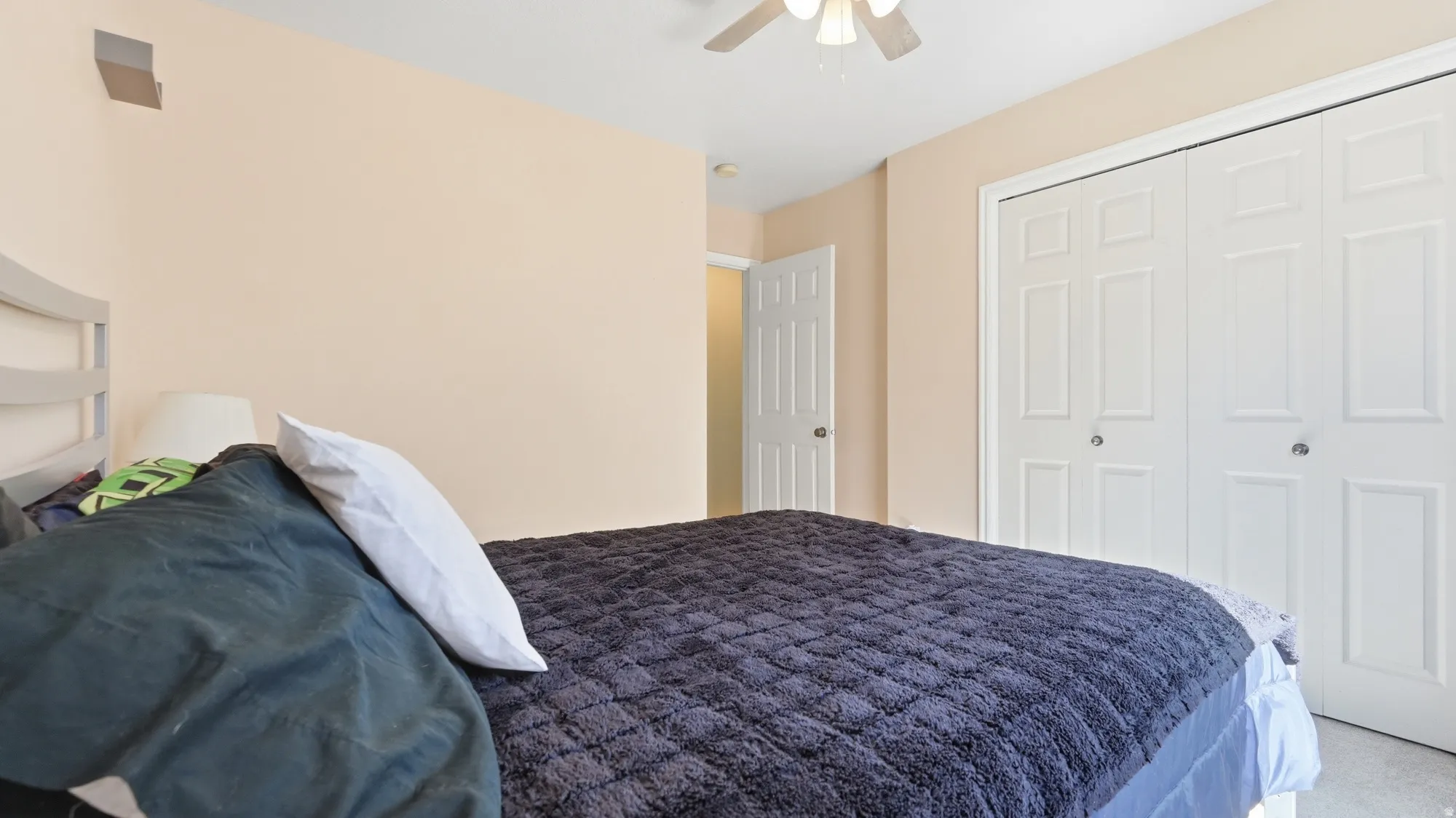 Second view of the bedroom showcasing the large double-door closet and plenty of usable floor space.