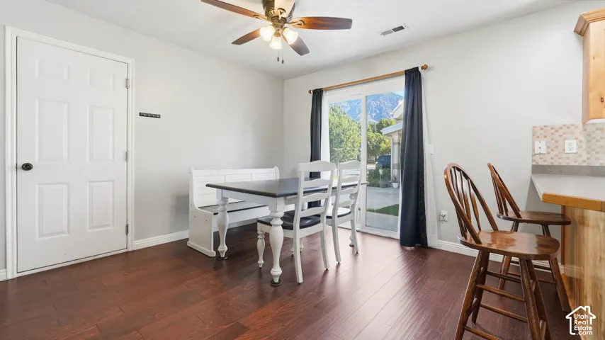 Bright dining area with beautiful flooring, sliding glass door for backyard access, and plenty of space for a full dining set.