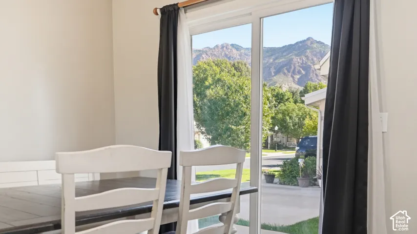 Dining area features a large sliding glass door showcasing beautiful mountain views and providing easy outdoor access.