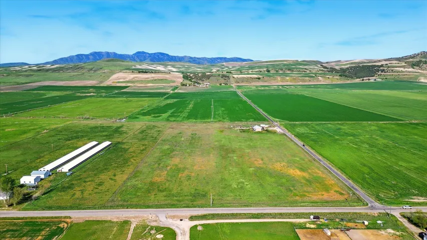 Expansive agricultural land featuring multiple cultivated fields and distant mountain ranges