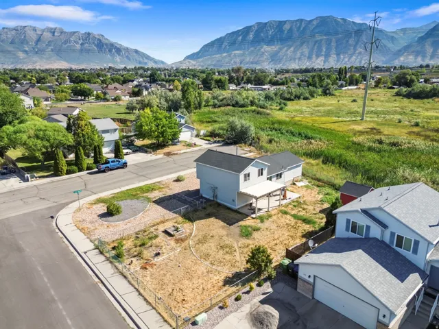 Two-story residence with a covered patio, fenced yard, and a corner lot location