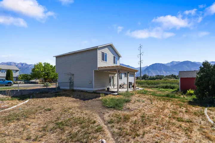 Two-story residence with light gray siding and a covered patio