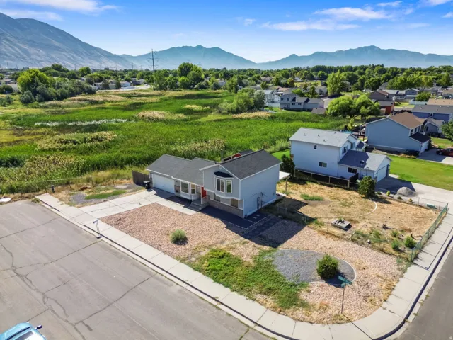 Single-level residence with a two-car garage, red front door, and a gravel front yard