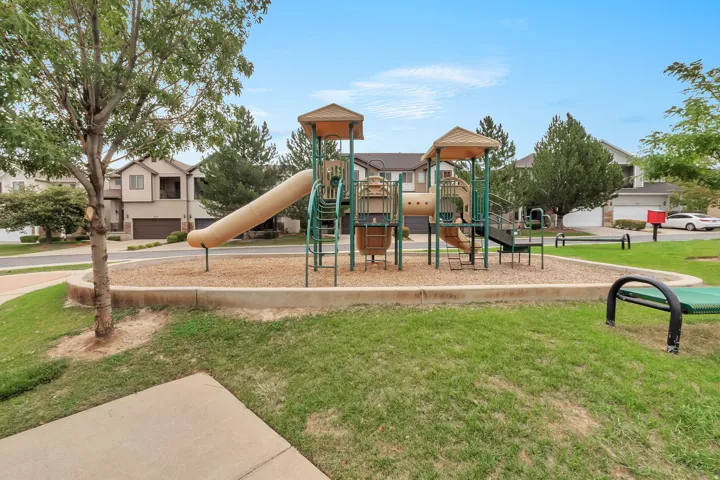 Community playground featuring a multi-level play structure with slides and climbing elements