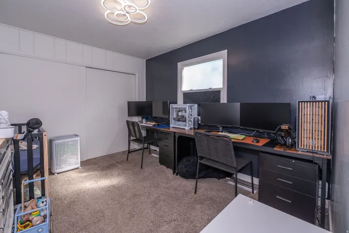 Carpeted room with a modern flush-mount ceiling light fixture