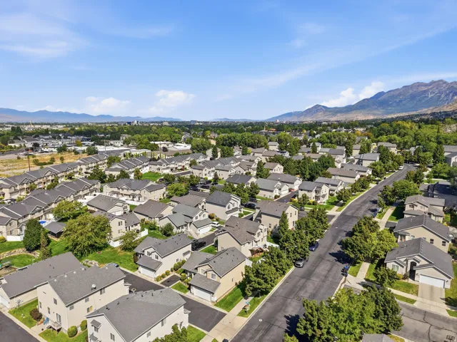 Residential neighborhood with a mountain backdrop and mature trees