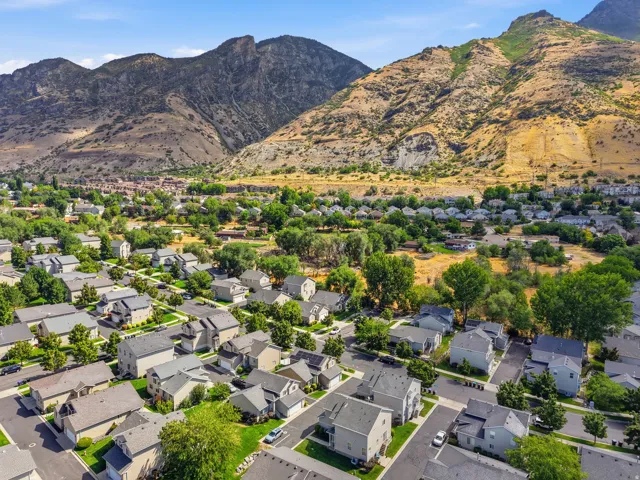 Residential neighborhood featuring mature trees and mountain scenery