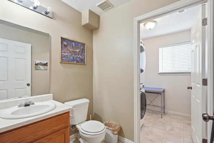 Vanity with an integrated sink, polished chrome faucet, and wood-finish cabinetry