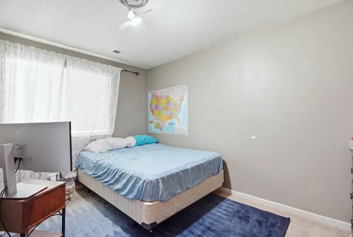 Recessed lighting, ceiling fan, window with curtain rod, and neutral wall paint